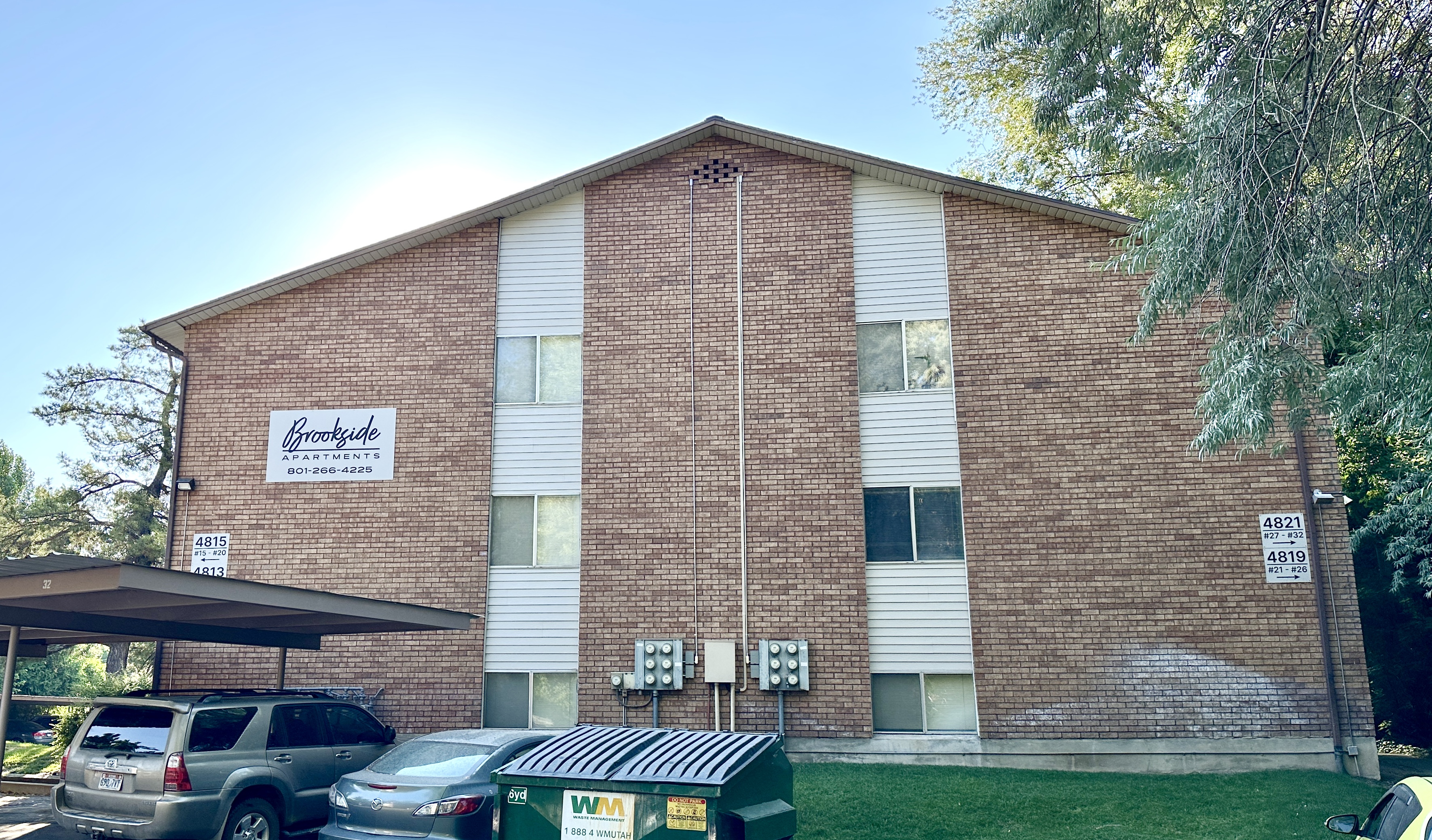 Brookside Apartments exterior with lush grounds